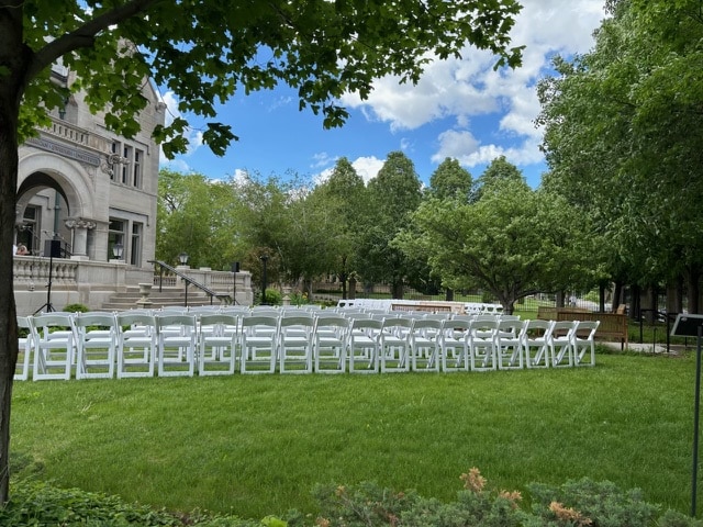 Lawn with white chairs in rows