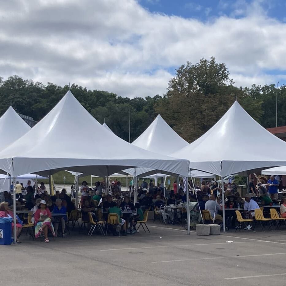 Crowd Under Tents at Outdoor Event
