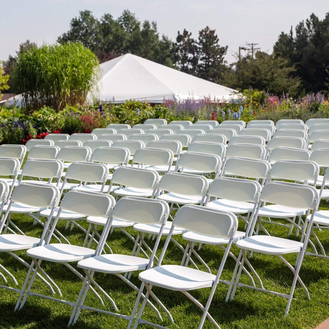 White Chairs Set Up for an Outdoor Wedding